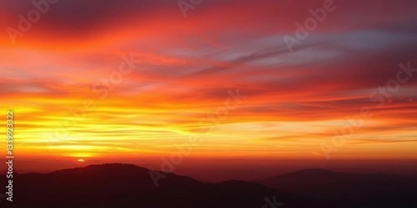 Obraz Fiery sunset gradient sky above hazy, indistinct mountain silhouettes, clouds, outdoors