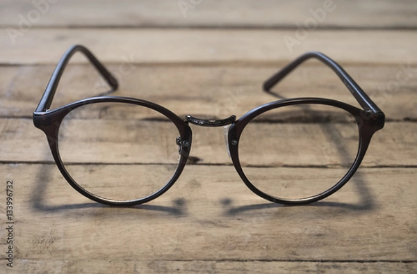 Obraz eyeglasses on wood table
