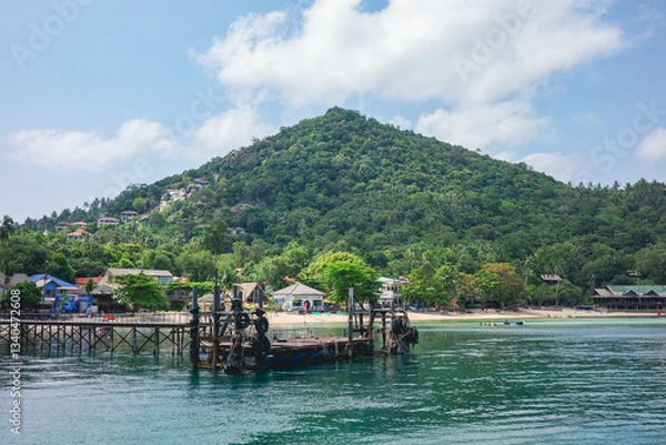 Fototapeta A beautiful landscape of the private boat dock to enter the resort with mountain in the background on Koh Tao, Thailand. A famous summer holiday destination for both locals and foreigners
