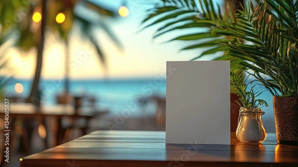Fototapeta Blank menu card on a wooden table in a tropical beach restaurant with ocean view, palm trees, and candlelight. Perfect for branding, advertising, or menu display. Banner with copy space.