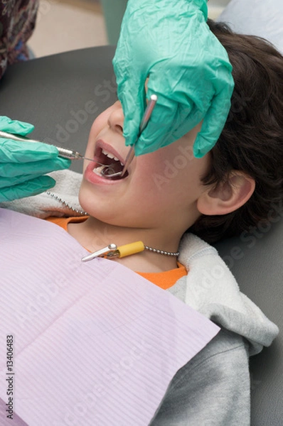 Obraz Young boy having his teeth checked and cleaned at the dentist