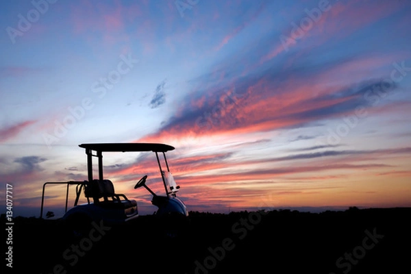 Fototapeta silhouette golf cart in golf course withcolorful twilight sky soft cloud for background backdrop use