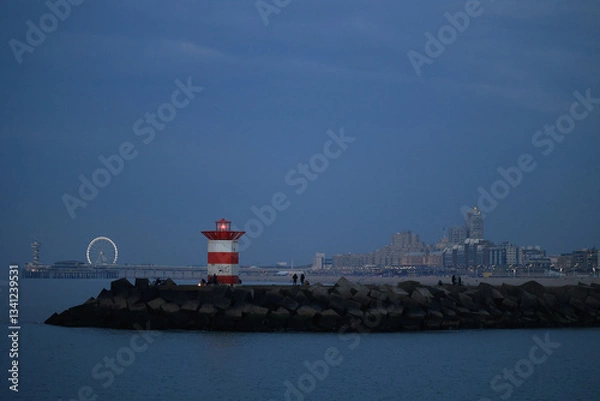 Fototapeta The Scheveningen is a modern seaside resort with a long, sandy beach, an esplanade, a pier, and a lighthouse in the evening. The Hague, Netherlands. 