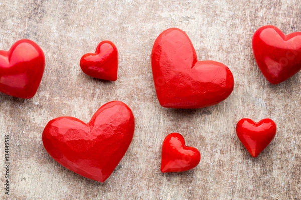 Fototapeta Red hearts on the wooden background.