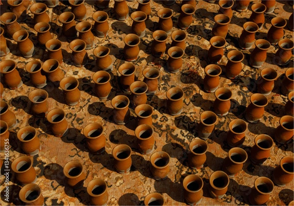 Obraz A background of claypots drying in th sunshine on a carpet