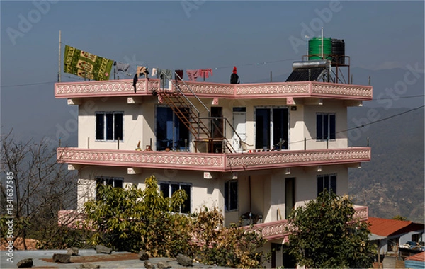 Obraz  building being lived in but still under construction on a hillside