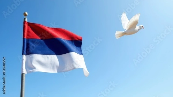 Obraz Serbian flag in wind with flying white dove and clear blue sky