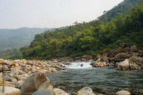 Obraz water flowing through rocky landscape