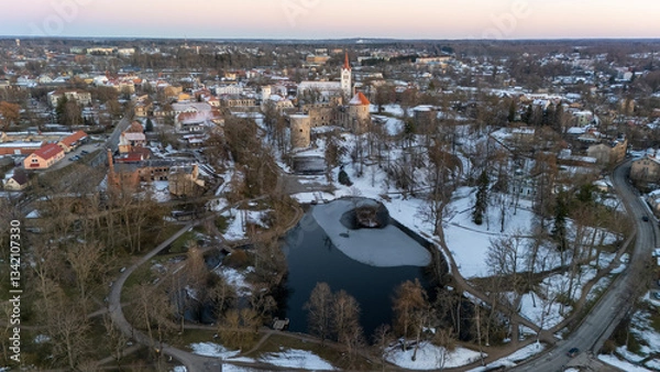 Fototapeta Cesis City, Latvia Aerial View With Medieval St. John’s Church and Ruins of the Beautiful Castle a Residence of the Livonian Order in the Middle Ages. Winter Evening Landscape at Sunset. City in snow
