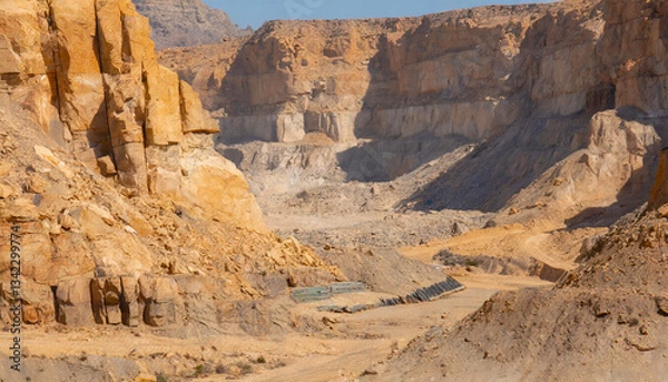 Fototapeta  A desert mining ground surrounded by sheer rock cliffs 