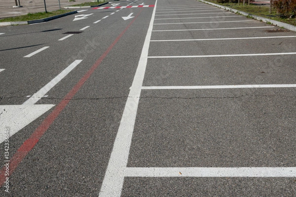 Fototapeta Parallel white stripes alternate with red to increase visibility. A universal urban symbol of mobility and road safety, crosswalks connect opposing sidewalks in cities around the world.