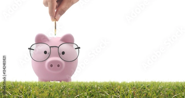 Obraz Saving for the future piggy bank with glasses home office financial planning bright environment close-up investment concept