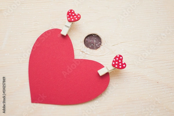 Obraz Red paper heart with pins on a wood table