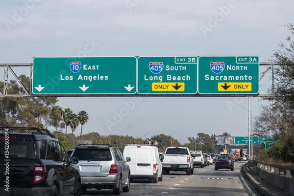 Fototapeta Slow traffic driving below freeway signs on the Santa Monica 10 freeway at the San Diego 405 freeway interchange in Los Angeles.  