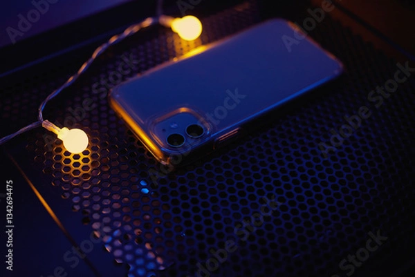 Fototapeta Smartphone at night on a technological table with neon lights.