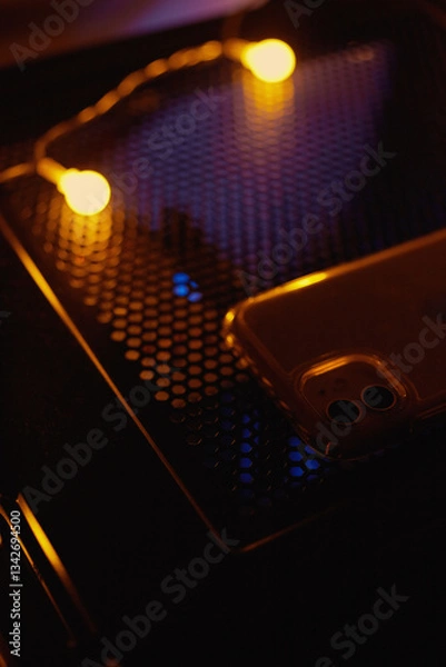 Fototapeta Smartphone at night on a technological table with neon lights.