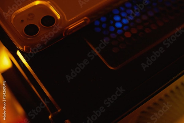 Fototapeta Smartphone at night on a technological table with neon lights.