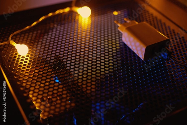 Fototapeta Phone charger at night on a tech table with neon lights.
