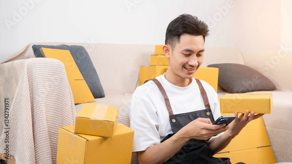 Fototapeta SME and packaging delivery concept. Portrait of Starting small businesses. Entrepreneurs check online orders to prepare to pack and sell to customers. use cellphone typing to courier