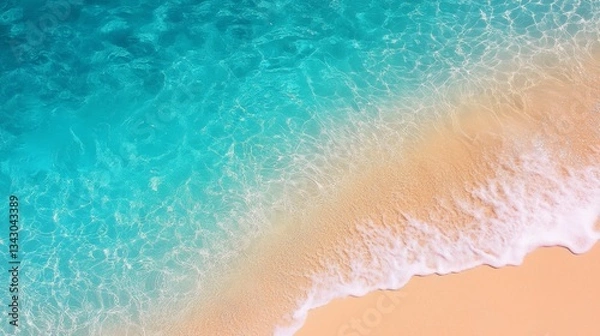 Fototapeta Crystal-clear turquoise water gently laps a sandy beach, creating a serene and picturesque scene.