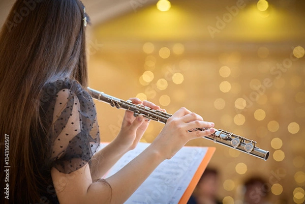 Obraz Flute Player Practicing with Sheet Music in Concert Hall. Copy space