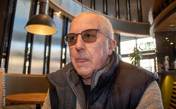 Fototapeta portrait of old man with glasses and a thoughtful face