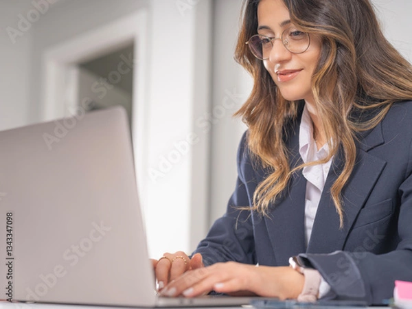 Fototapeta Smiling businesswoman using laptop, cropped close up image of confident caucasian 20s brunette smiling businesswoman using laptop typing. Female confident employee office worker satisfies with results