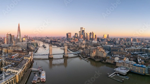Fototapeta Tower bridge, London Tower, with surrounding skyscrapers of the downtown, at dawn, wide aerial view