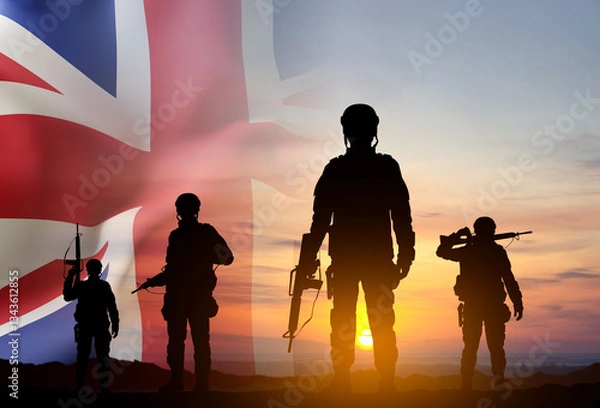 Obraz Silhouettes of a soldiers with United Kingdom flag against the sunset. Background for Remembrance Day. United Kingdom Armed Forces concept