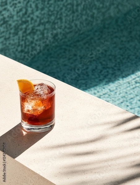Fototapeta Refreshing Cocktail by the Pool: A Summer Drink with Ice and Orange Slice for a Relaxing Vacation, Alcoholic Beverage, and Tropical Vibes.