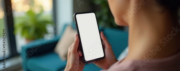 Obraz Female figure in relaxed pose holding a smartphone screen with blank display surface, home, phone