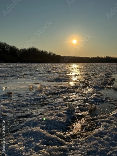 Fototapeta Ice Age far away at the Arctic pole in the snowy mountains in winter. Global warming and melting transparent blocks of ice. Spring atmosphere on a river or lake