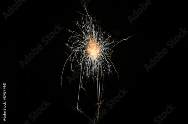 Fototapeta Golden orange amazing fireworks isolated in dark background close up, New Year, explode