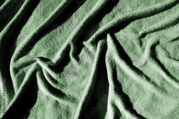 Fototapeta Plaid douillet pastel plissé froissé vert pour faire un arrière plan pour des présentation de textile, matériau, décoration, dans l'univers du linge de lit, doux et accueillant