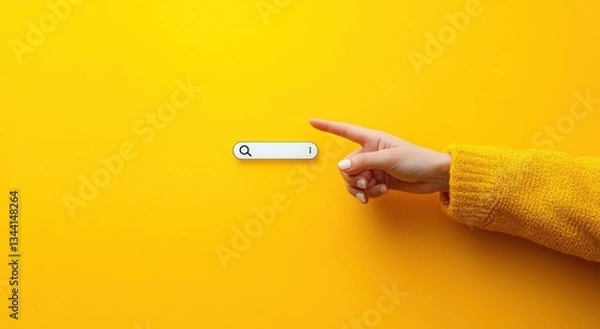 Obraz Hand Pointing Towards Modern Search Bar Interface on Yellow Background with Soft Shadows and Bright Lighting