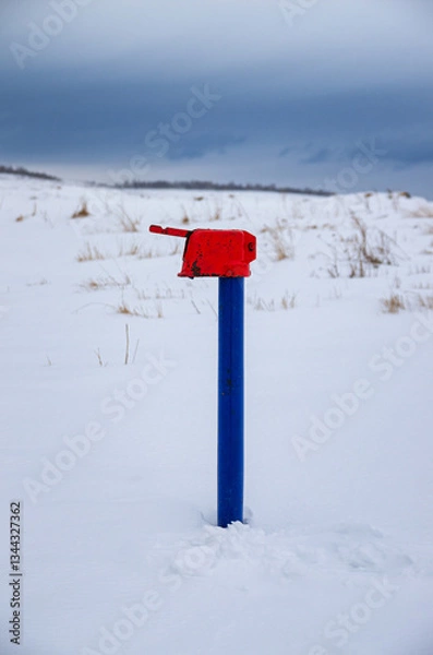 Obraz A water column in the field in winter.