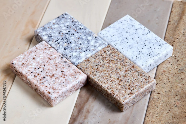 Fototapeta Porcelain stoneware artificial stone square samples as kitchen countertop examples of future kitchen fasade exterior. Samples slabs of natural granite marble quartz for stone countertops close up.