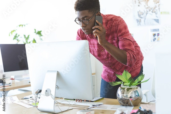 Obraz In office, professional multitasking using smartphone and computer efficiently