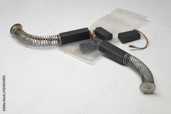 Fototapeta DC motor contact carbon brushes, with copper wire shunt, kit with push spring, spare element, expendable parts of electric motors, brand new elements, transparent plastic bag. closeup