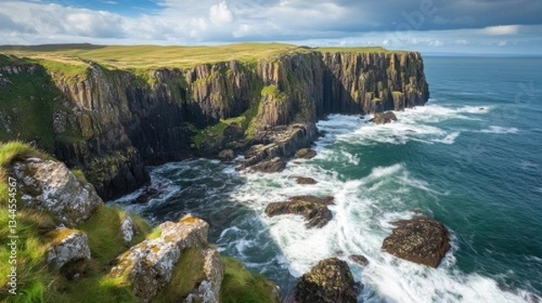 Fototapeta Dramatic coastline vista featuring rugged cliffs and dynamic ocean waves crashing