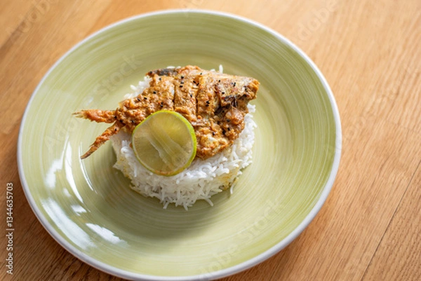Obraz Fish curry with rice. Spicy pomfret fish curry gravy.