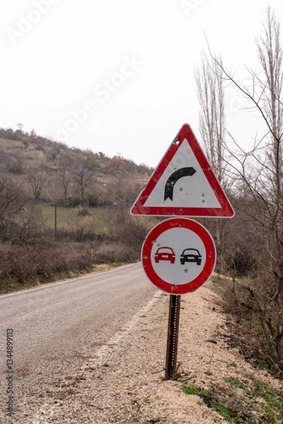 Fototapeta Sharp Curve and No Overtaking Road Sign
