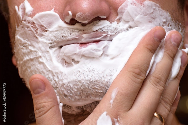 Fototapeta Man causes the foam to the face