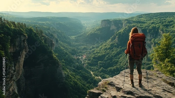 Fototapeta A hiker exploring Liechtensteins FÃ¼rstensteig Trail with rugged cliffs and valleys