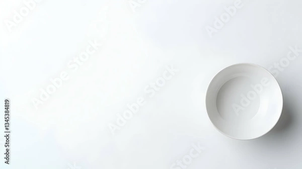 Fototapeta Isolated White Ceramic Bowl On A Plain White Background Viewed From Above With Soft Lighting And Subtle Shadows