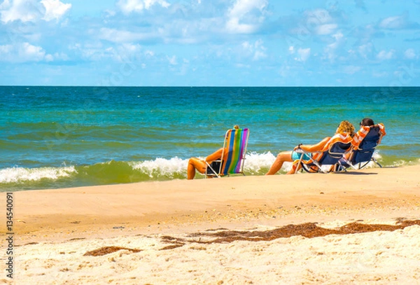 Obraz Tourists on beach vacation enjoy ocean water views St George Island Florida