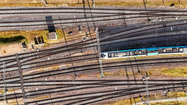 Fototapeta Railroad, train tracks and train aerial drone view from above, railway station in the Netherlands, transportation and public transport infrastructure concept