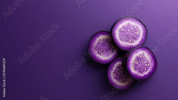 Fototapeta Purple Food and Drink A sliced eggplant with visible seeds and texture, vibrant purple color against a contrasting background.