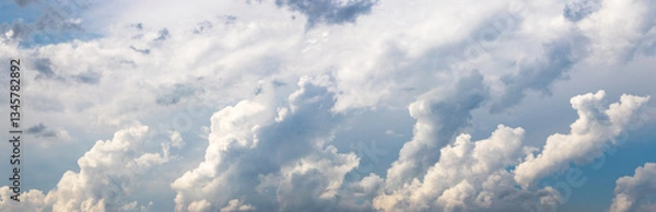 Fototapeta panorama of the sky with large cumulus clouds forming a dynamic pattern