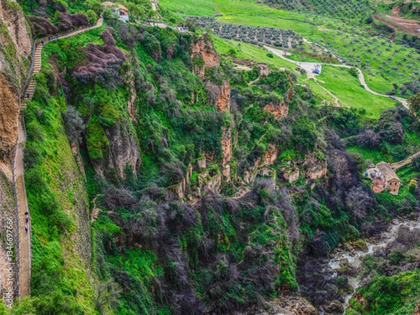 Fototapeta Ruins perched precariously on cliff face at Ronda, Andalusia, Spain.
